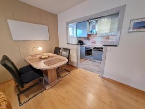 a small kitchen and dining room with a table and chairs at Wattwurm in Wyk auf Föhr