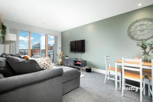 a living room with a couch and a dining room at Vanburgh Court Apartments in Slough