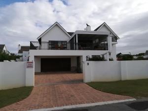 a large white house with a large garage at Trev's Place in St Francis Bay