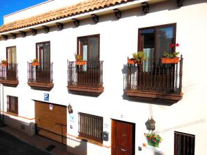 un edificio blanco con balcones y flores. en Casa Rural Jardín del Desierto, en Tabernas 37 fotos más