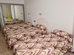 A bed or beds in a room at Apartamentos Catalina Park