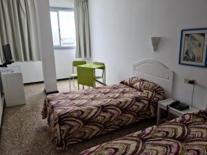 A bed or beds in a room at Apartamentos Catalina Park