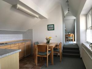 a kitchen and dining room with a table and chairs at Hotel-Pension Seeadler in Prerow