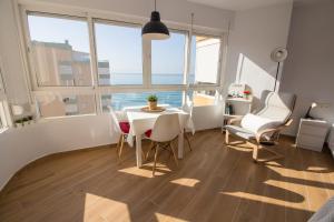 a dining room with a table and chairs and windows at MADRID 810 in Torrox Costa