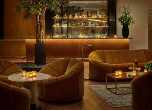 a lobby with couches and tables and a bar at ModernHaus SoHo in New York
