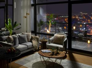 a living room with a view of a city at night at G Tower Furnished Apartment Rentals in Istanbul