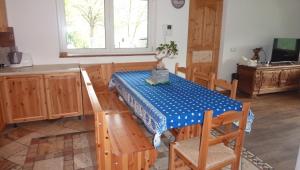 a kitchen with a table with a blue and white table cloth at Villa Dream alla Beppa in Tenno