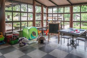 a room with a classroom with a table and chairs at Ośrodek Edward in Mikoszewo
