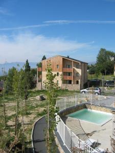 a house with a swimming pool in front of a house at Résidence Néméa Les Chalets Du Belvédère in Font-Romeu