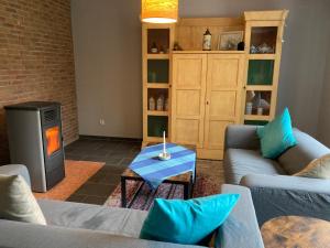 a living room with two couches and a fire place at Haus Wald und Wiese Wohnung Wald in Ehndorf