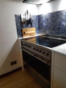 a kitchen with a stove and a counter top at Song of the Sea, Selkie House in Helmsdale