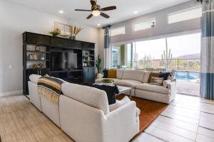 a living room with two couches and a tv at Cactus Flower Pass in Marana