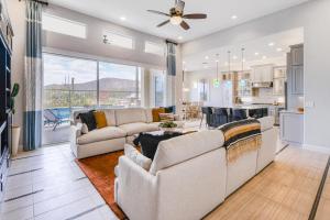 a living room with two couches and a kitchen at Cactus Flower Pass in Marana