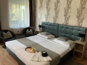 Posteľ alebo postele v izbe v ubytovaní Oleander Apartman