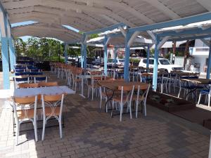 a group of tables and chairs under a pavilion at Hotel Scala in Paralia Rachon