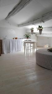 a room with a table and a bed and a table and chairs at sacrobosco apartment Pioppo in Bomarzo