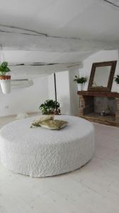 a white room with a bed with a pillow on it at sacrobosco apartment Pioppo in Bomarzo