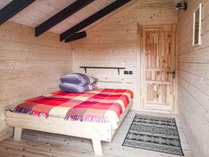 a wooden cabin with a bed in a room at Котедж Скеля in Vorokhta