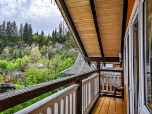 a balcony of a home with a view of the mountains at Котедж Скеля in Vorokhta