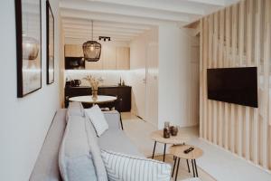 a living room with a couch and a table at Forest House Pobierowo in Pobierowo