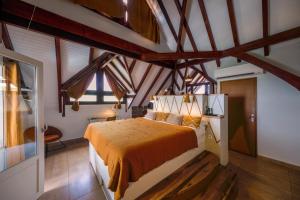 a bedroom with a bed in a room with wooden ceilings at La Suite Villa in Les Trois-Îlets