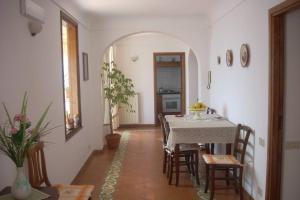 a dining room with a table and chairs at East wind house in Praiano