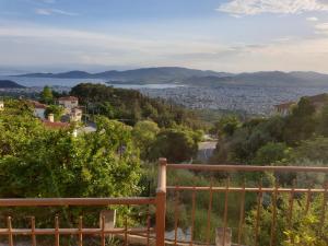 a view of a city from a hill with a fence at Apartment in Anakasia overlooking Volos in Volos