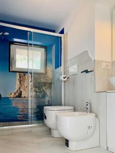 a bathroom with a toilet and a glass shower at Casa Manì in Anacapri