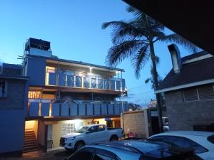 a white truck parked in front of a house at Caphill Hotel in Syokimau