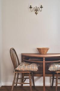 a dining room table with two chairs next to a desk at Half Moon Cottage in Stockland