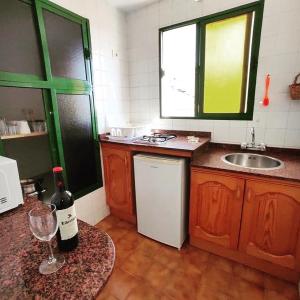 a kitchen with a bottle of wine on a counter at Apartments Casa Lila in Puerto de Mogán