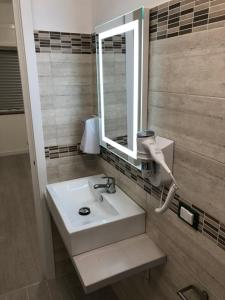 a bathroom with a sink and a mirror at B&B Le Palme in Diamante