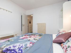 a bedroom with a bed with a blue blanket on it at Porec TWINS Apartment in Poreč