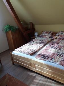 a large bed in a room with at Bora Vendégház in Eger