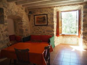 a dining room with a table and a window at Domaine De Pradines in Lanuéjols