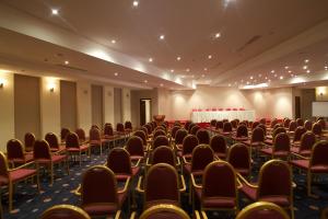 an empty room with chairs and tables in it at Hala Hotel & Aqua Park in Bissau +159 photos