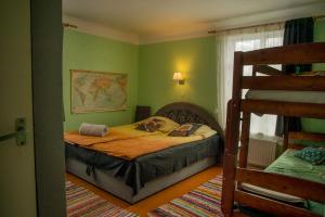 a bedroom with a bed in a room with green walls at Timemachine Apartment in Valmiera
