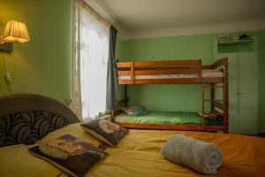 a bedroom with two bunk beds and a bed at Timemachine Apartment in Valmiera
