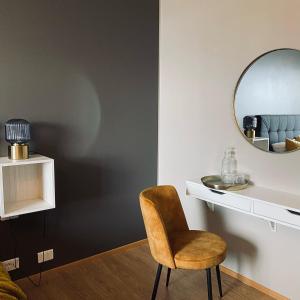 a room with a chair and a mirror at Guesthouse Stekkab&oacute;l in Patreksfj&ouml;r&eth;ur