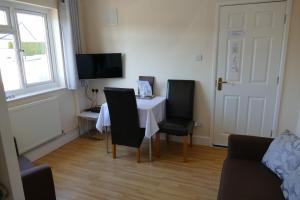 a dining room with a table and two chairs at Magnolia Self Contained Suites in Bristol