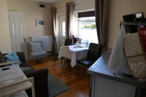 a dining room with a white table and chairs at Magnolia Self Contained Suites in Bristol