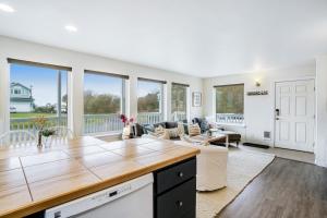 a kitchen and living room with a couch and a table at Little Blue Beach House in Pacific Beach