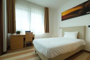 Posteľ alebo postele v izbe v ubytovaní Hotel Portavaldera