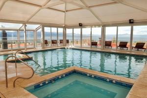 a swimming pool with a view of the ocean at Monasterio Hotel Boutique in San Carlos de Bariloche