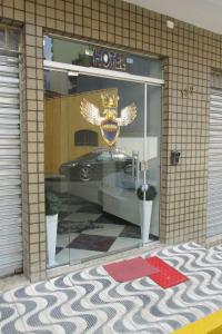 a window of a hotel with a car in it at Golden Apart Hotel in Aparecida