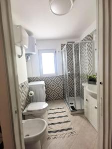 a bathroom with a toilet and a sink and a shower at Emidio House in Termini