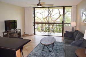 a living room with a couch and a table at Beautiful Private Condo Walking Distance to Beach MV2321 in Kihei