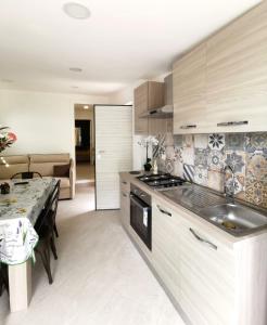 a kitchen with a sink and a stove top oven at Emidio House in Termini