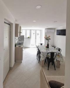a kitchen and dining room with a table and chairs at Emidio House in Termini