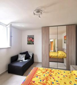 a living room with a bed and a couch at Emidio House in Termini